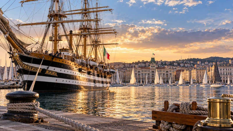 Illustrazione editoriale IA ultrarealistica dell'Amerigo Vespucci nel porto di Trieste durante Barcolana; scena non documentaria.